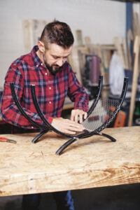 man placing wire mesh on the inside of the bolted bicycle rims and wrapping it&hellip;